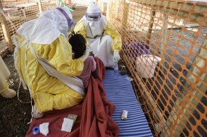 Kailahun. Sierra Leone. Médicos S Sans Frontières (MSF) Ebola Treatment Center. MSF doctors try to feed a young girl in the high contamination risk zone of the treatment centre.