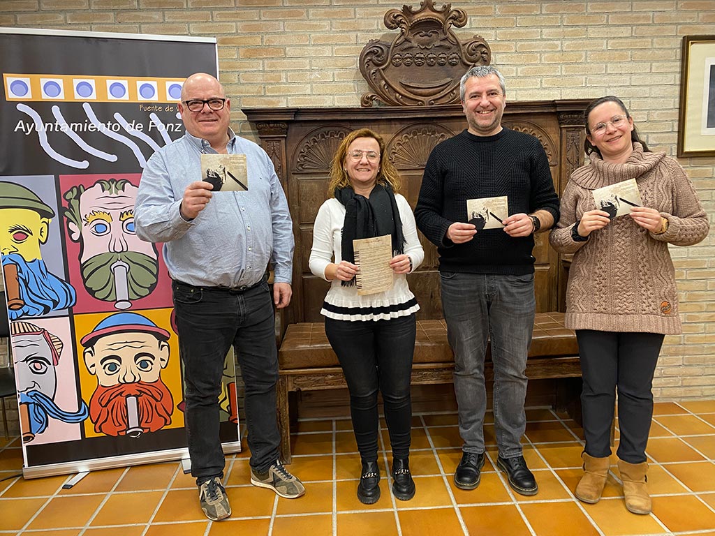 cuatro personas posando con el cartel de certamen literario