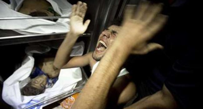 Un hombre llora desconsolado ante los cadáveres de los niños fallecidos mientras jugaban en una playa. Foto: Mahmud Hams