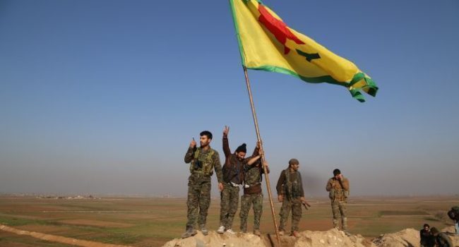 La bandera kurda de las YPG ondea en una cima de Kobane (Rojava). Foto: DIHA