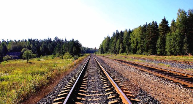 Una vía de tren rodeada a verde