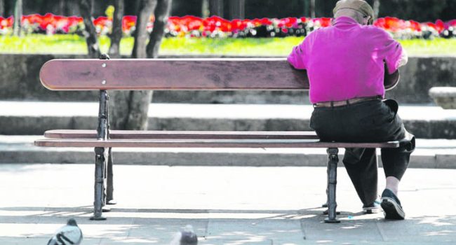 Man sits on a bench in central Pontevedra